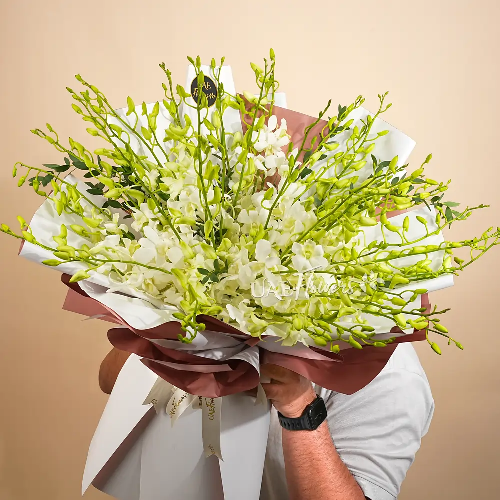 40 pristine white orchids in a lush bouquet
