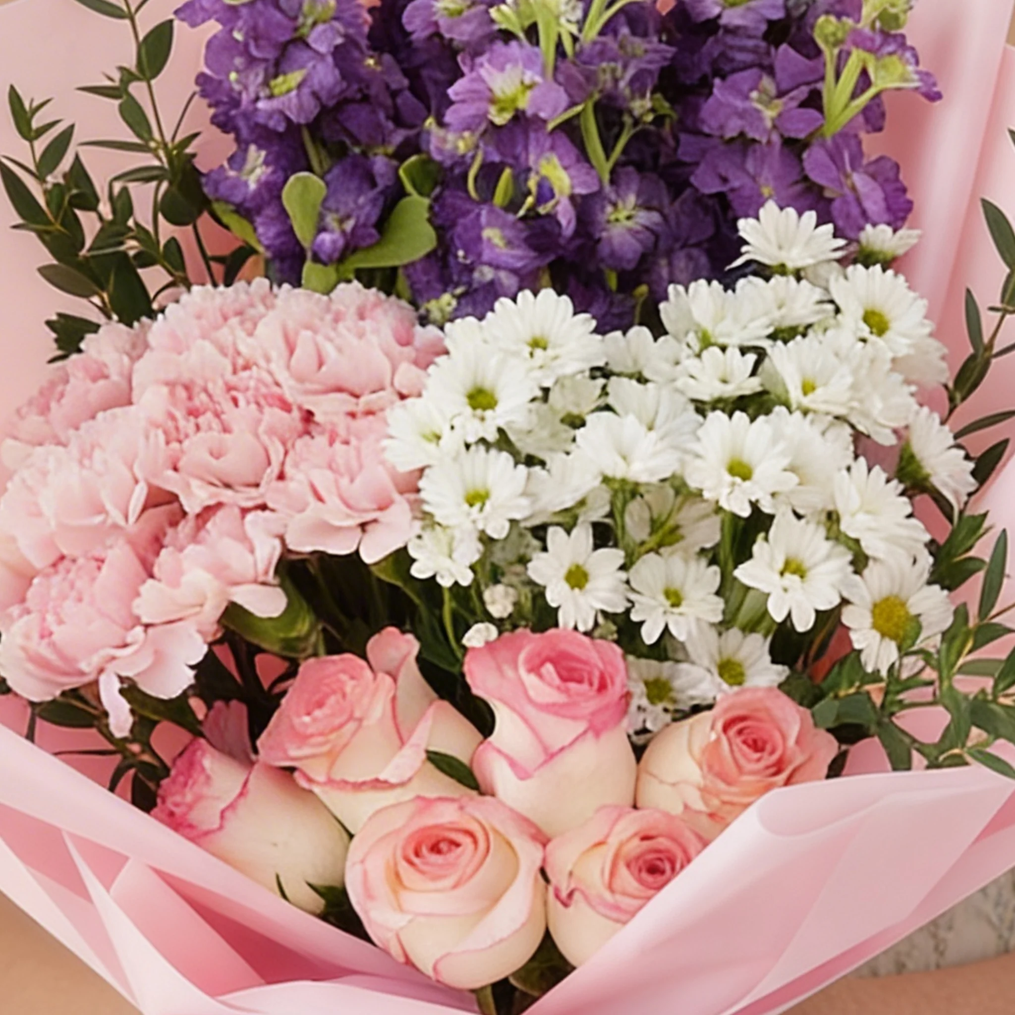 Bouquet of 8 pink carnations, 6 pink roses, 6 purple matthiola and 3 white chrysanthemums with green fillers in pink wrapping.