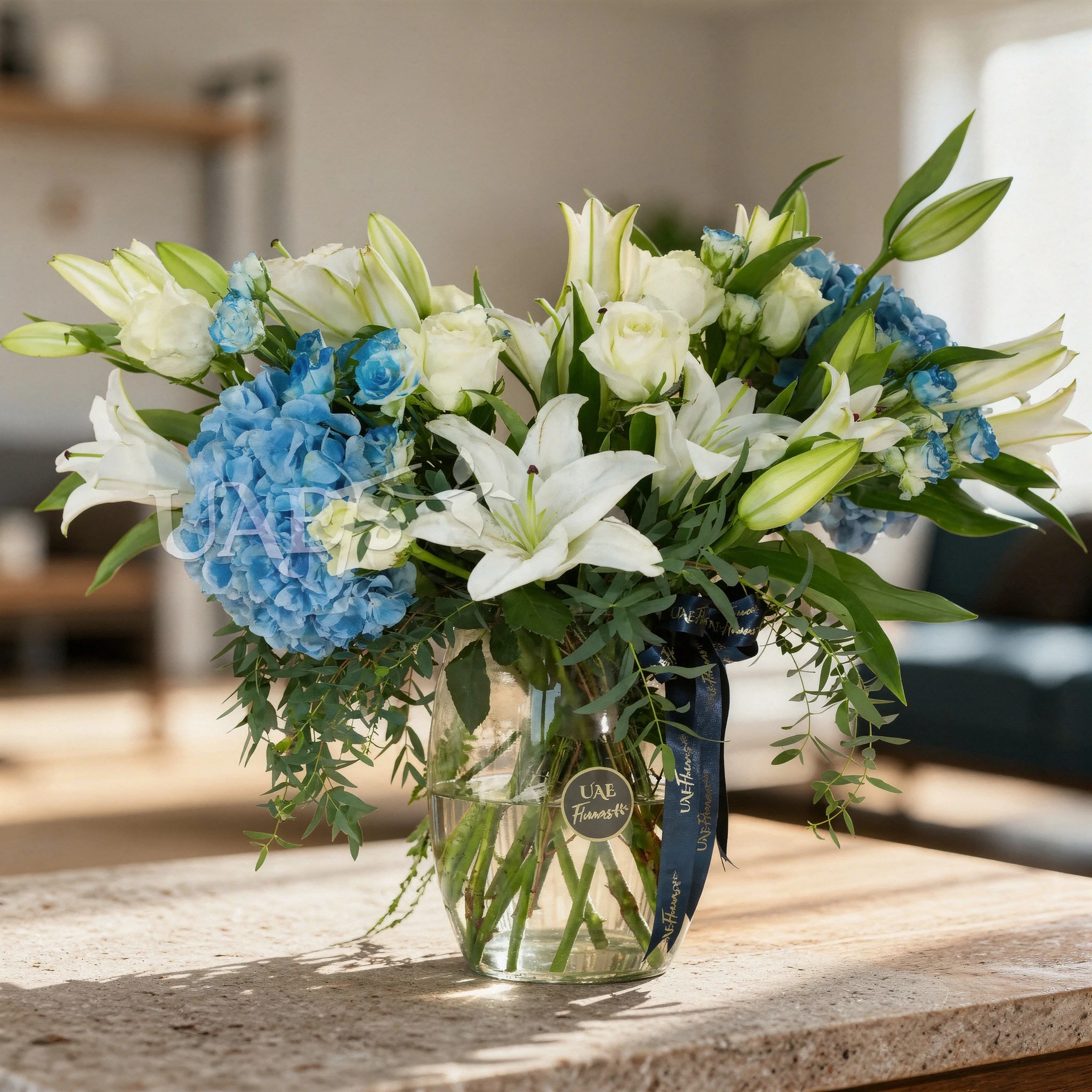 2 blue hydrangeas, 4 white lilies, 5 white roses & 2 blue spray roses