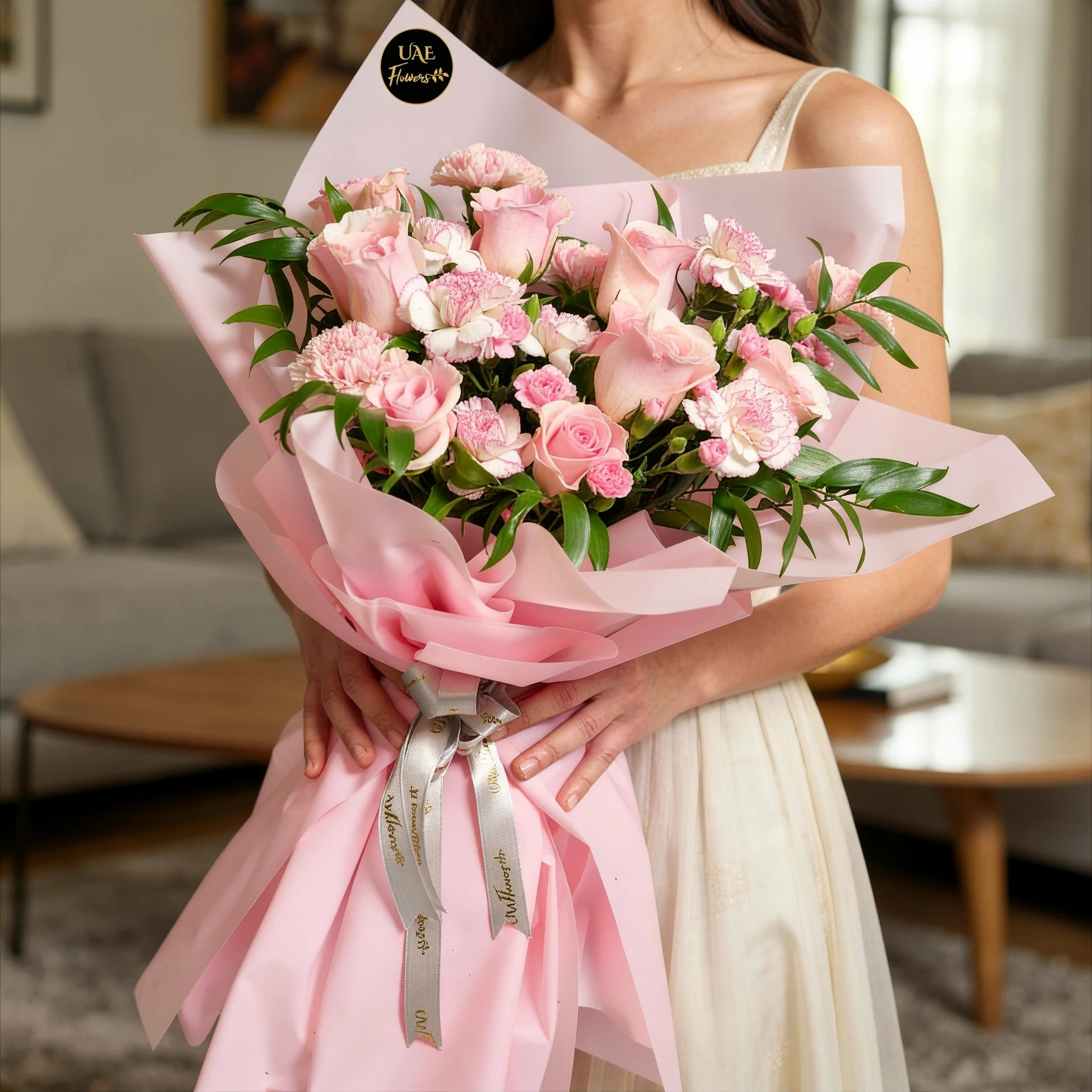 Bouquet of 6 pink roses, 6 pink carnations, 3 pink spray carnations with green fillers in pink wrapping.