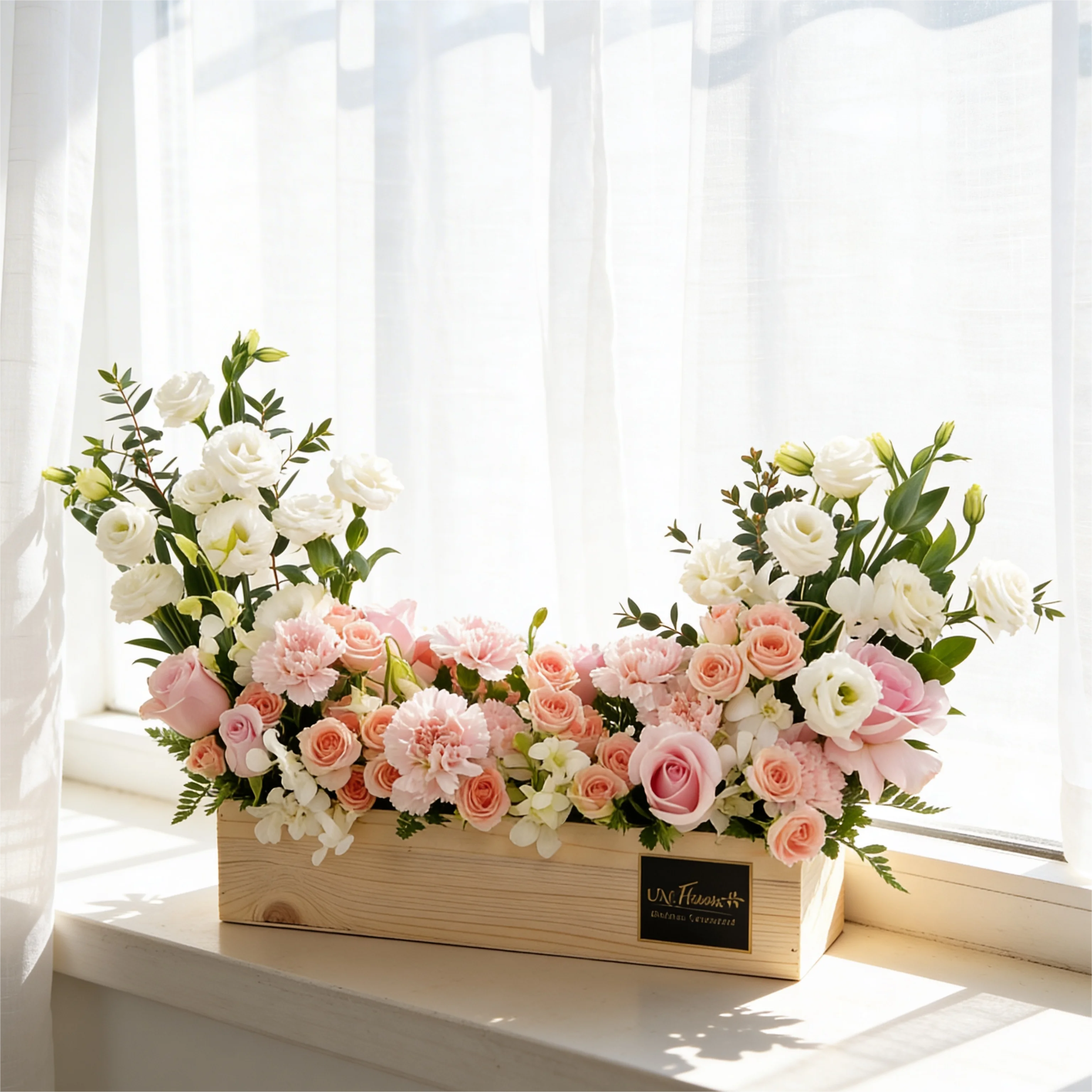 5 pink roses, 6 pink carnations, 3 pink spray roses, 3 white lisianthus and 2 white orchids with green fillers in a wooden tray.