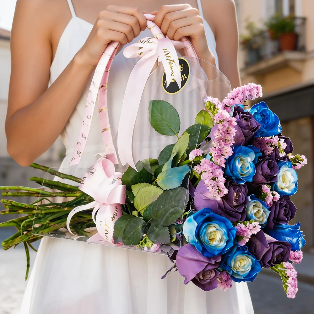 7 purple roses and 7 blue roses with pink statice in an acrylic bag tied