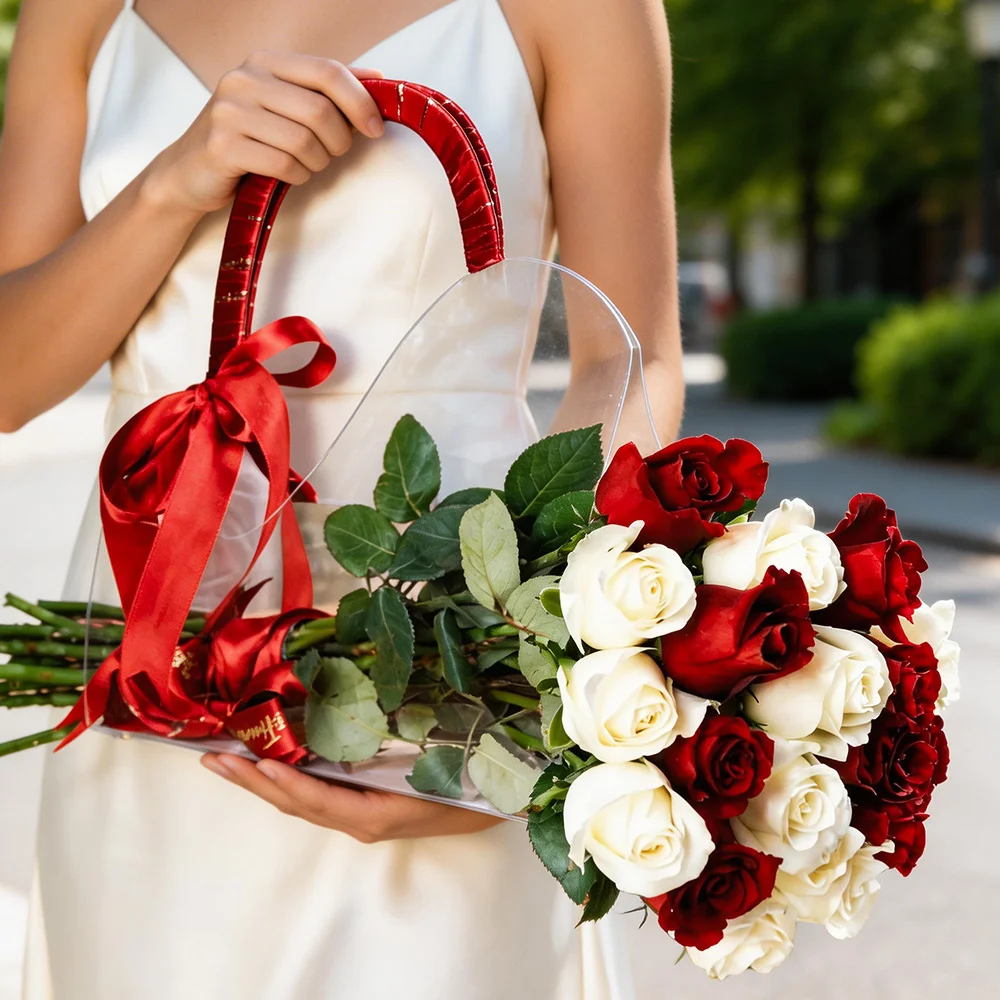18 red and white roses placed in a clear acrylic bag tied with red ribbons