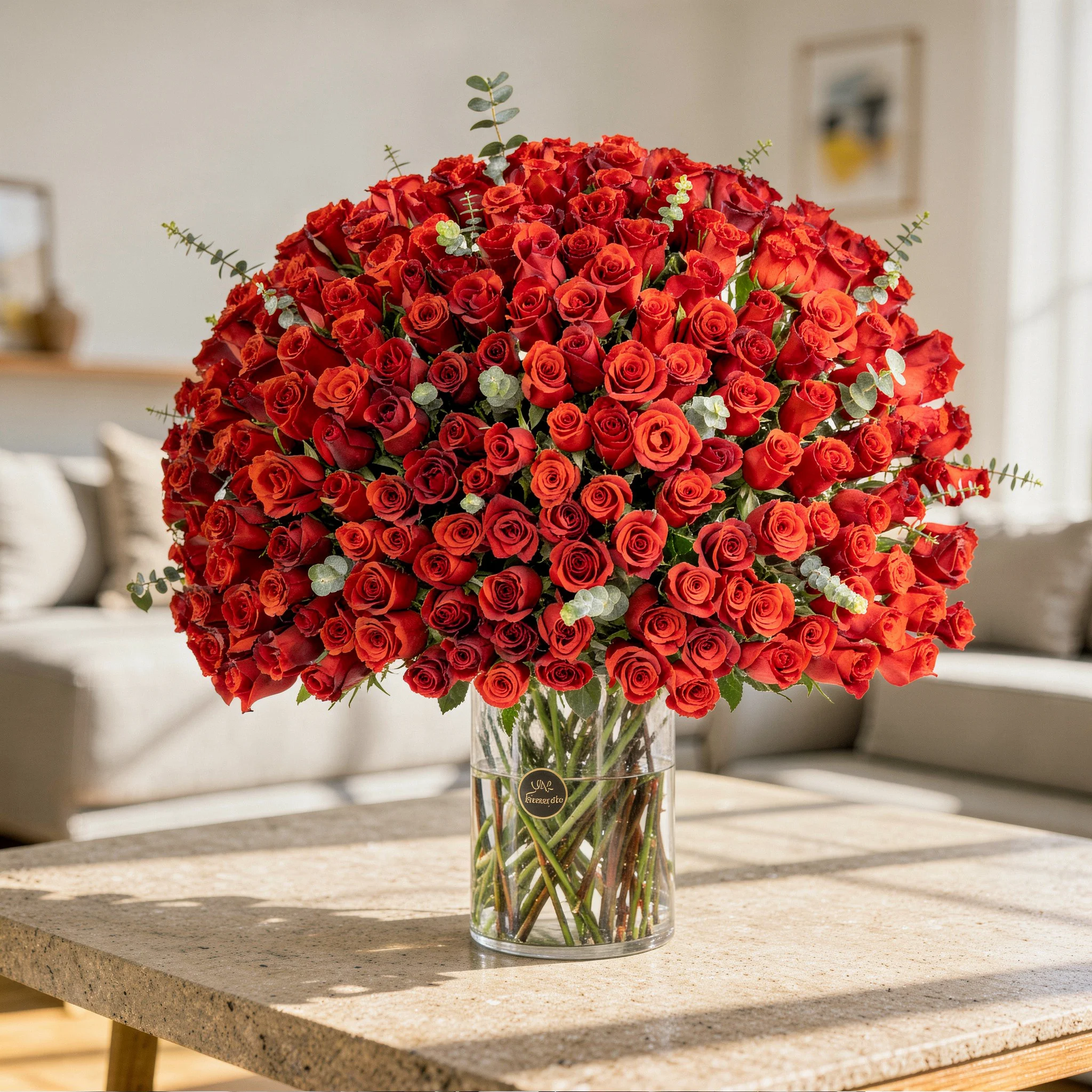 200 red roses with green fillers in a glass vase.