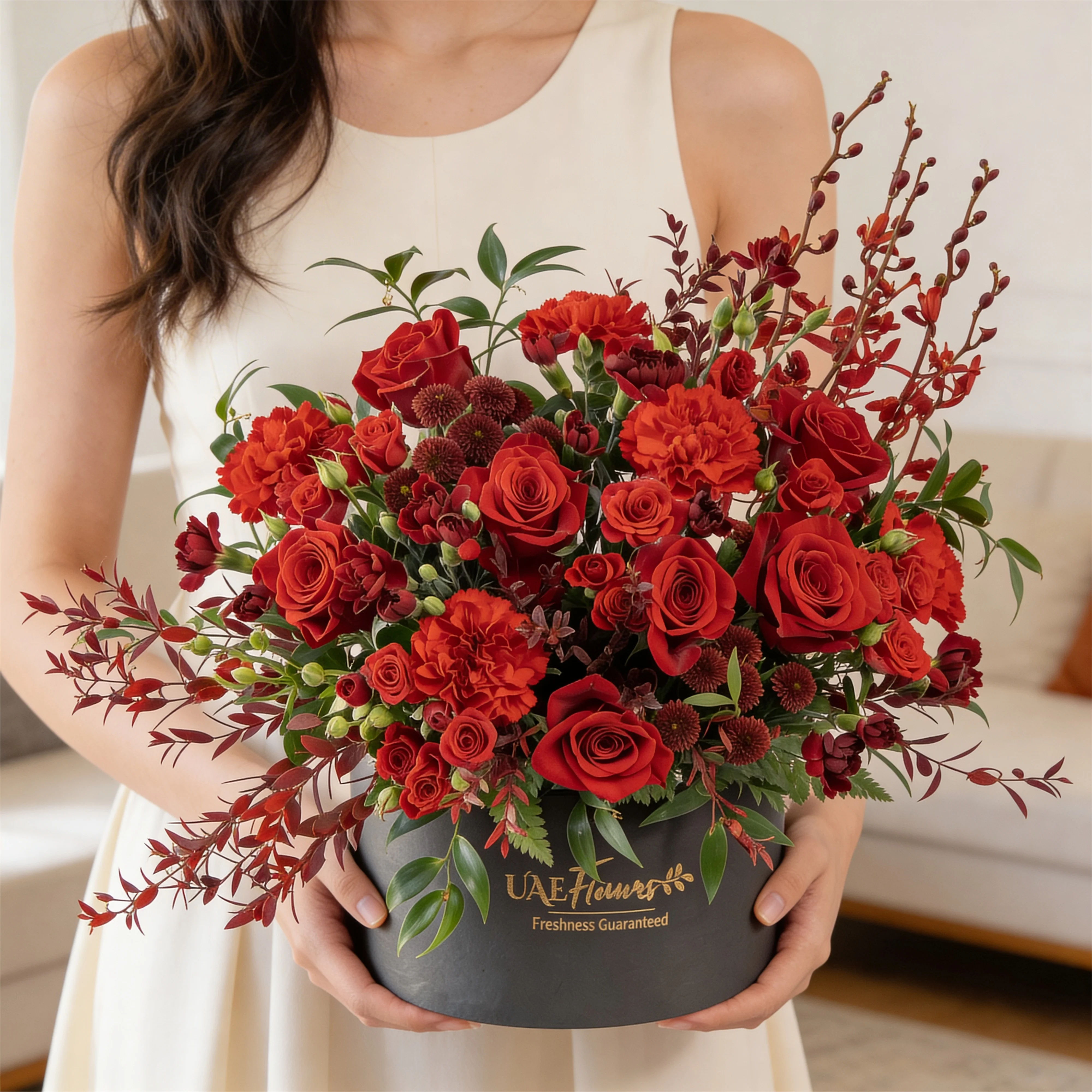 4 annie black orchids, 8 red roses, 3 red spray roses, 2 red chrysanthemums and 4 red spray carnations with green fillers in a round box.