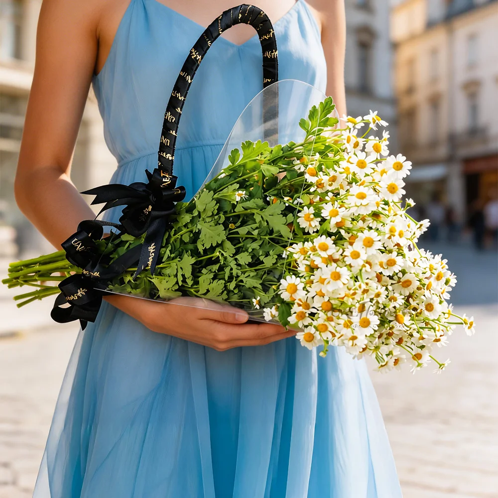 10 Tenacetum flowers arranged in an acrylic bag tied with a black ribbon