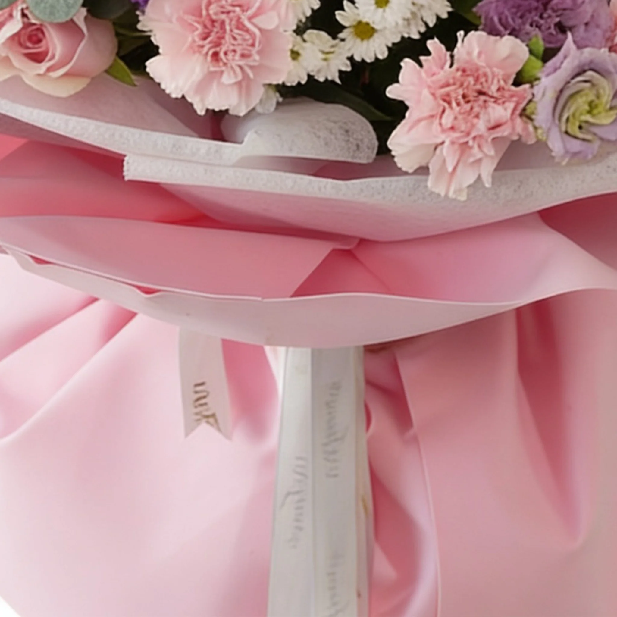 Bouquet of 10 purple matthiola, 10 white chrysanthemums, 10 purple lisianthus, 30 pink carnations and 50 pink roses with green fillers in nice wrapping.