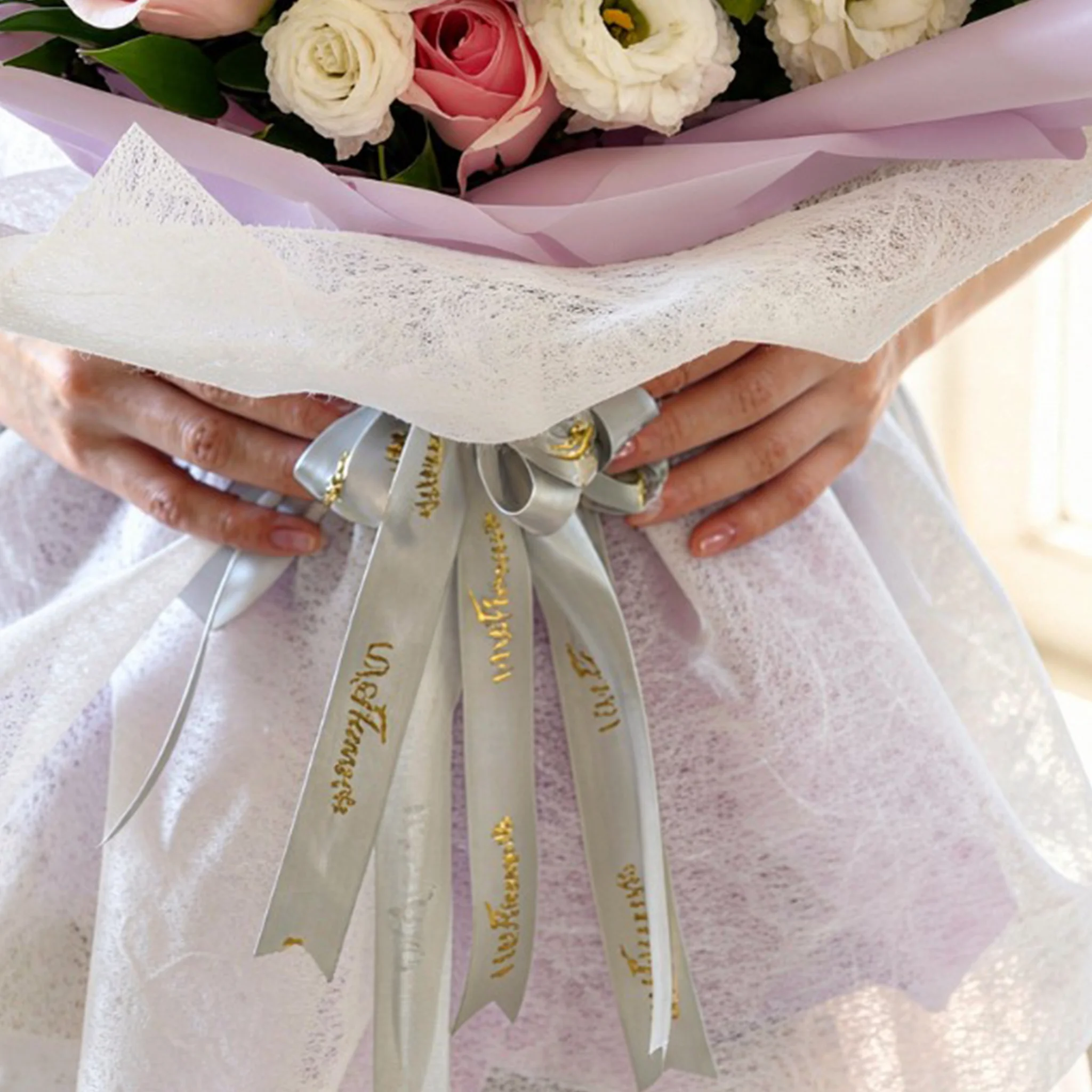 Bouquet of 2 white lilies, 10 purple matthiola, 5 white lisianthus and 8 pink roses with green fillers in nice wrapping.