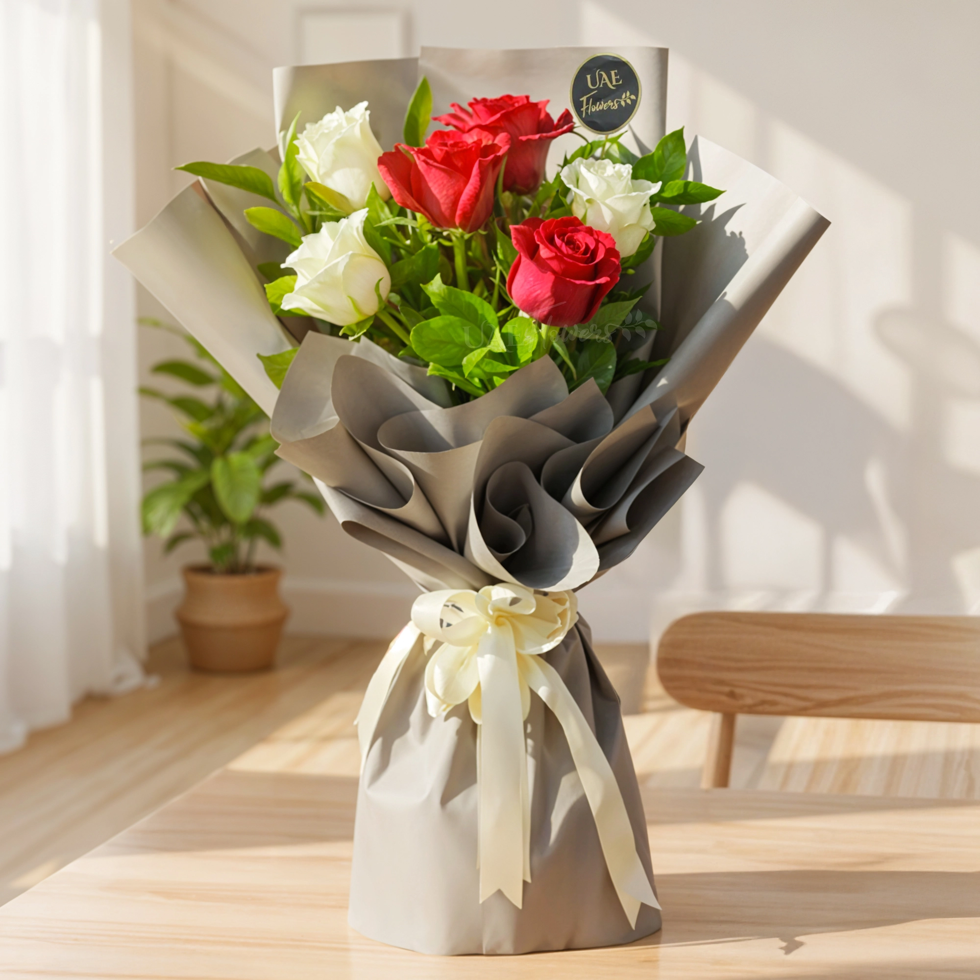 bouquet of 3 red roses and 3 white roses with fresh green fillers