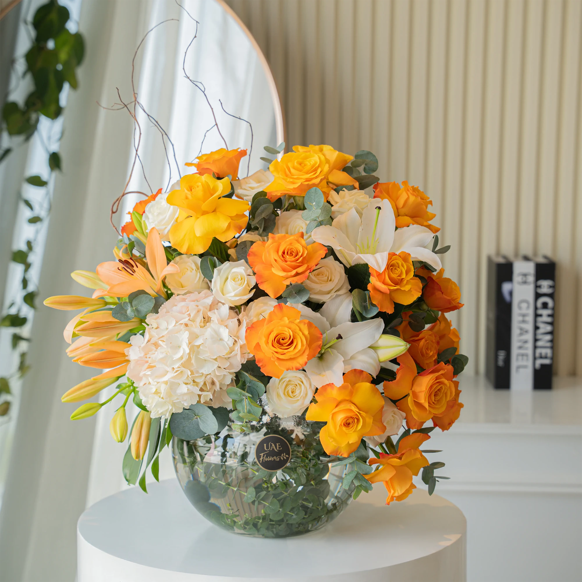 Orange roses, white lilies, and hydrangeas in glass vase for Diwali by UAE Flowers Dubai