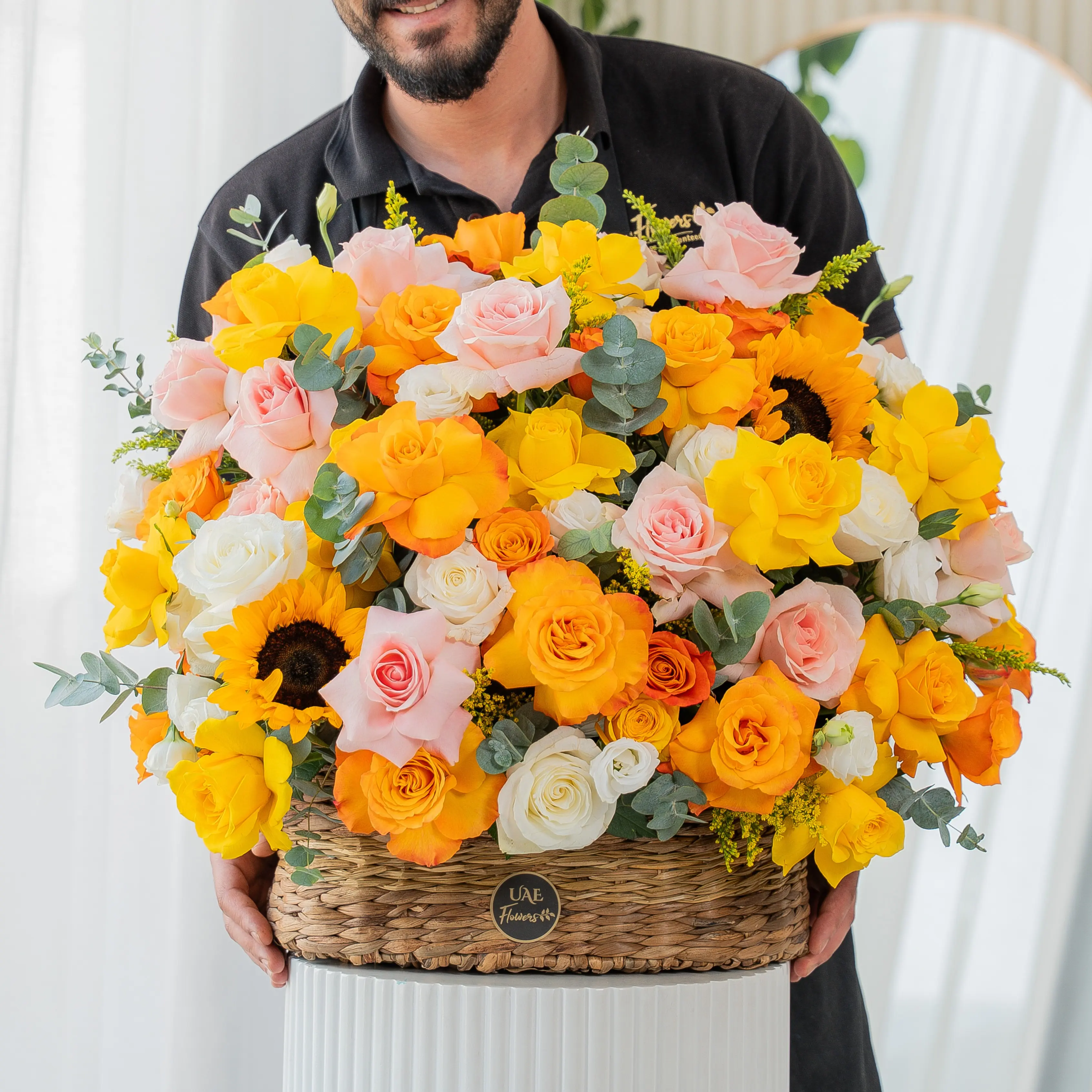 Yellow, peach, and orange roses with sunflowers in basket for Diwali by UAE Flowers Dubai