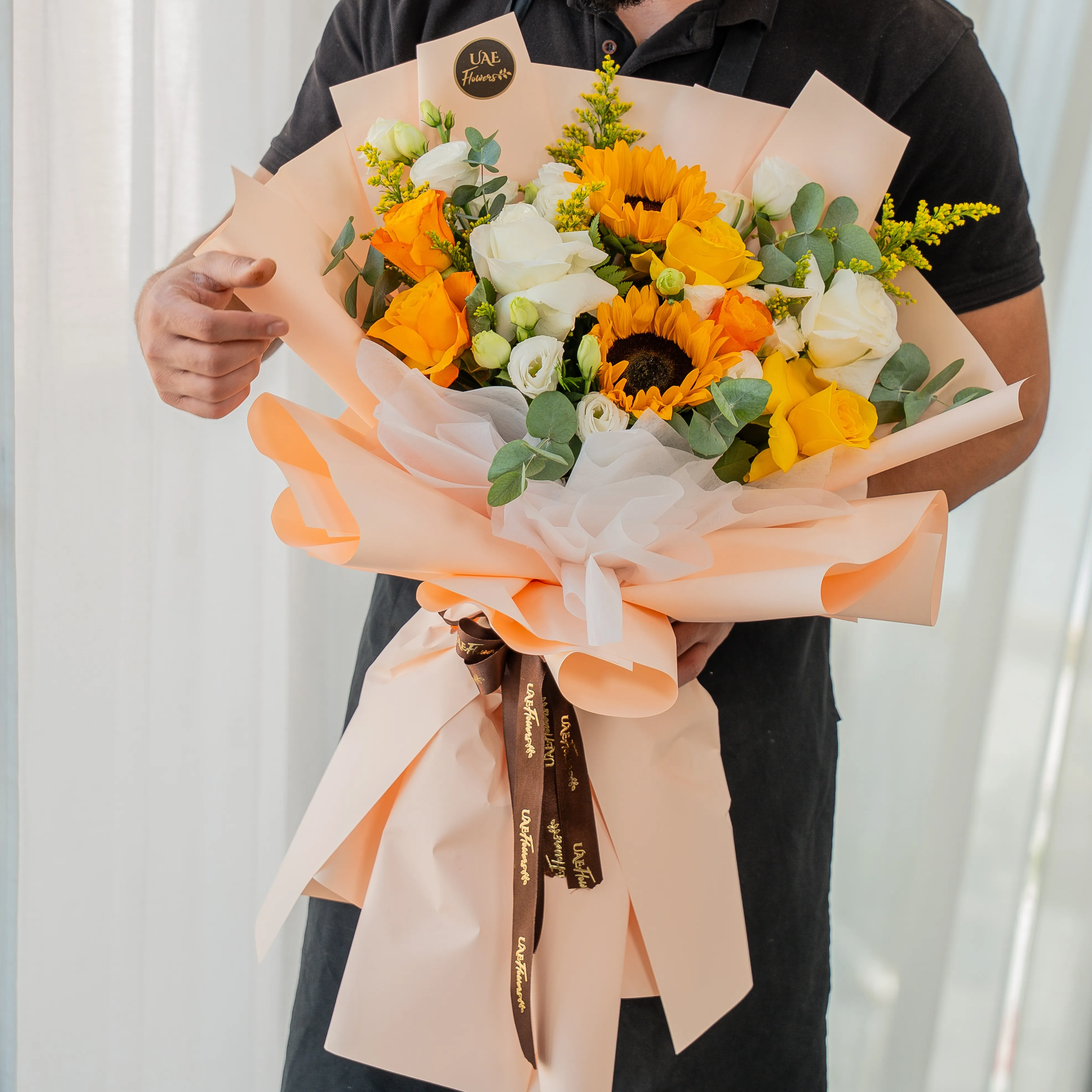 Sunflowers, yellow and white roses bouquet wrapped for Diwali by UAE Flowers Dubai