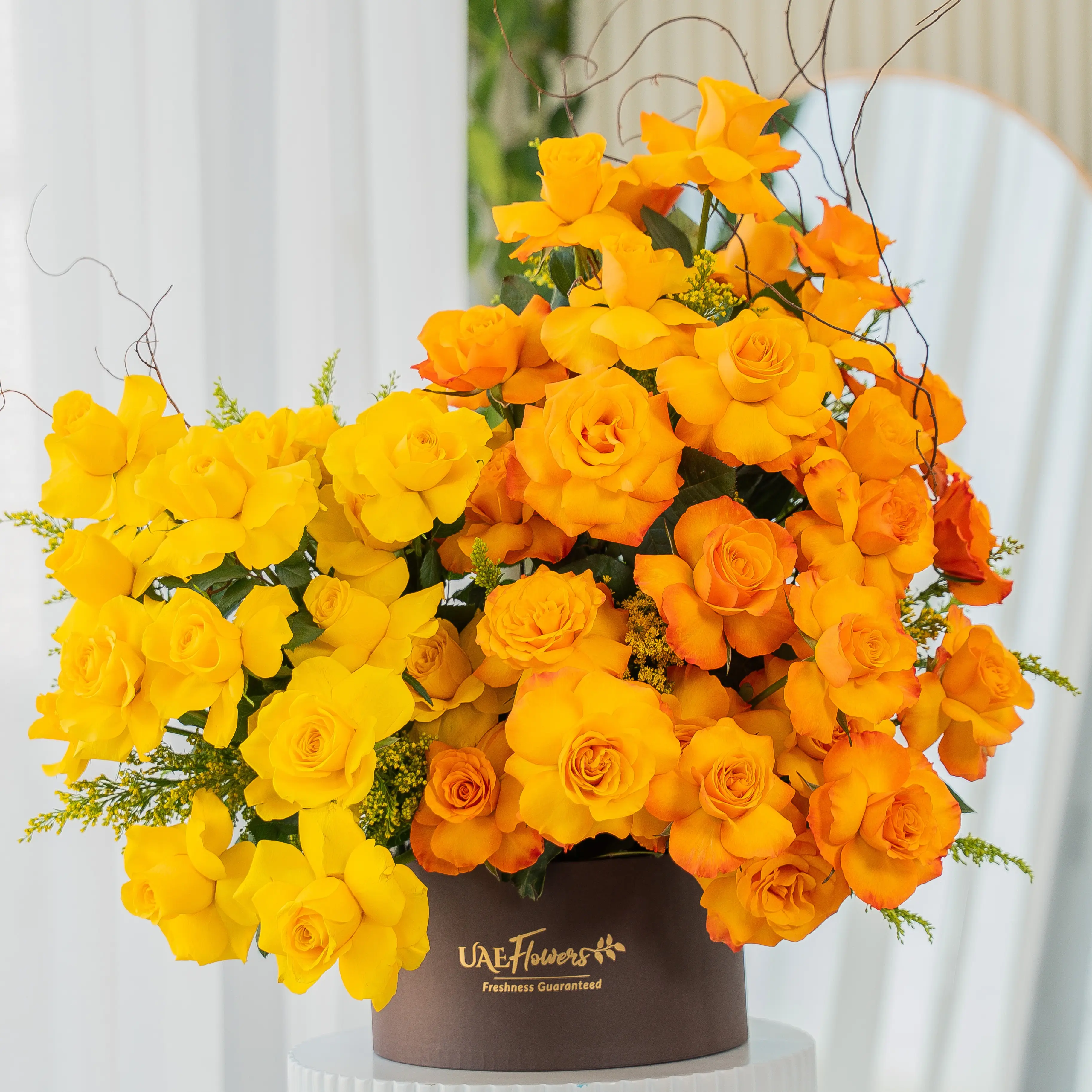 Yellow and orange roses in luxury hatbox for Diwali by UAE Flowers Dubai