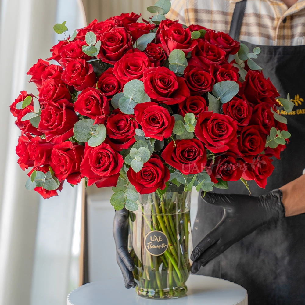 Vase of 50 red roses with eucalyptus leaves