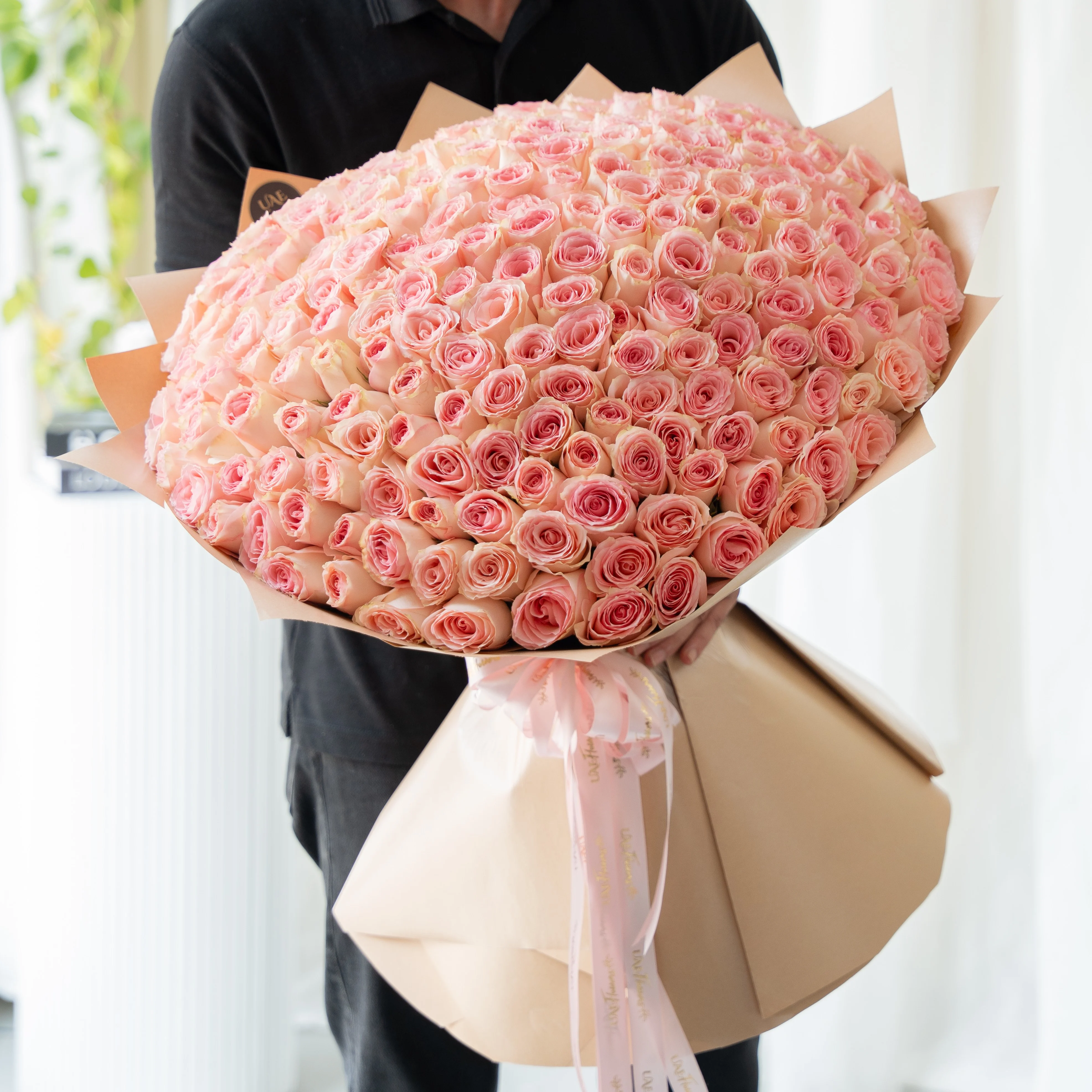 bouquet of 200 pink roses arranged with soft fillers