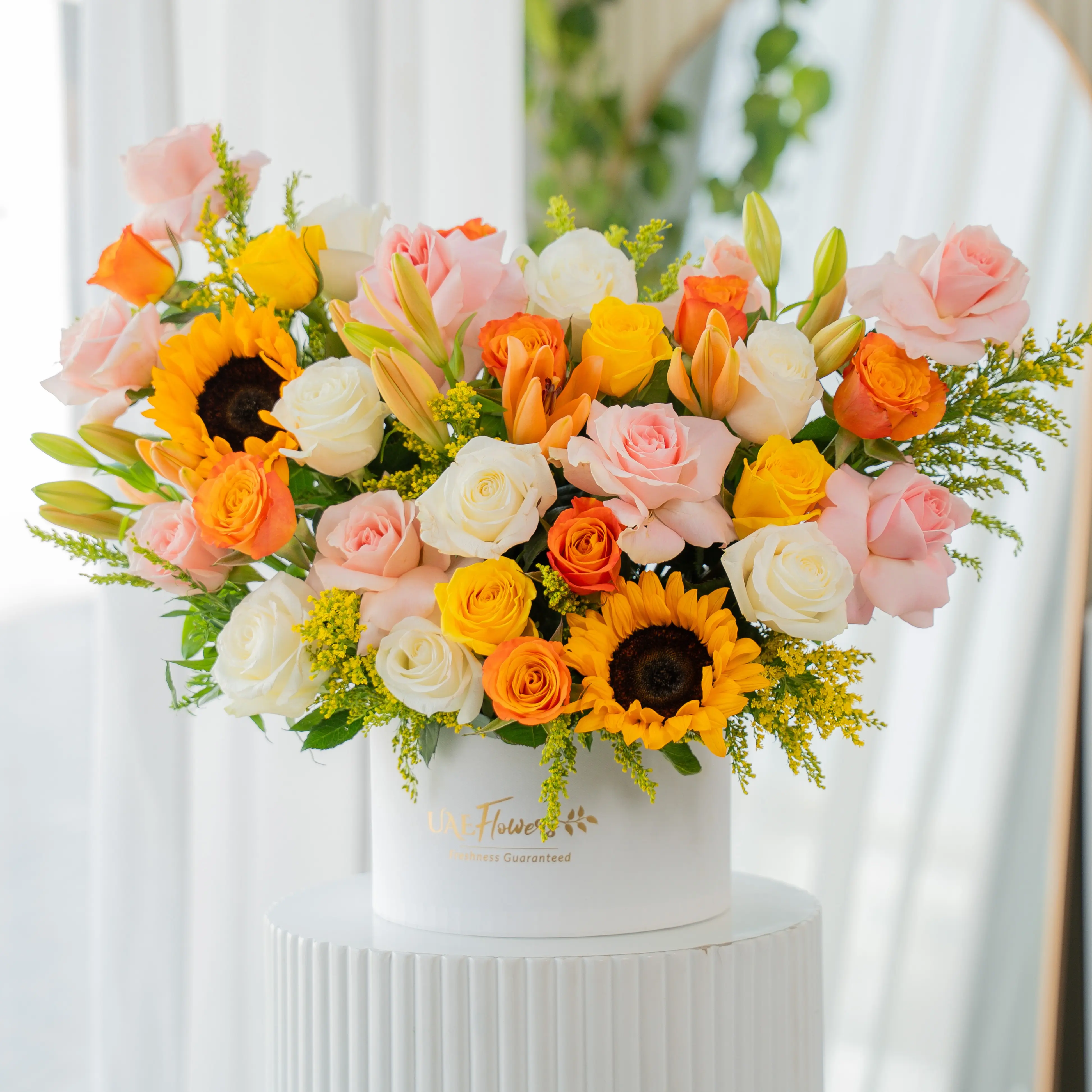 Sunflowers, lilies, and roses in a luxury white hatbox for Diwali by UAE Flowers Dubai