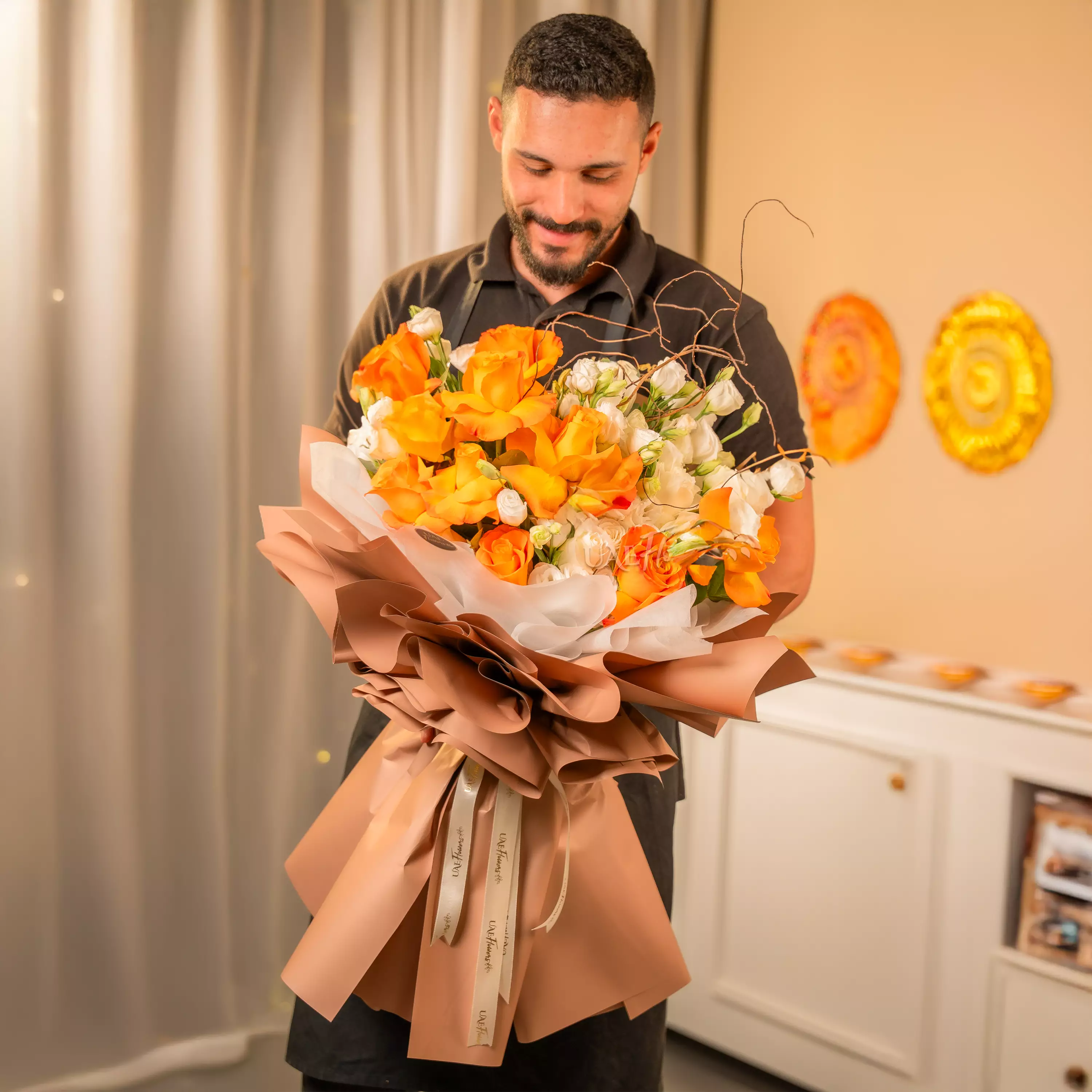 Orange and white rose bouquet with festive wrapping for Diwali by UAE Flowers Dubai