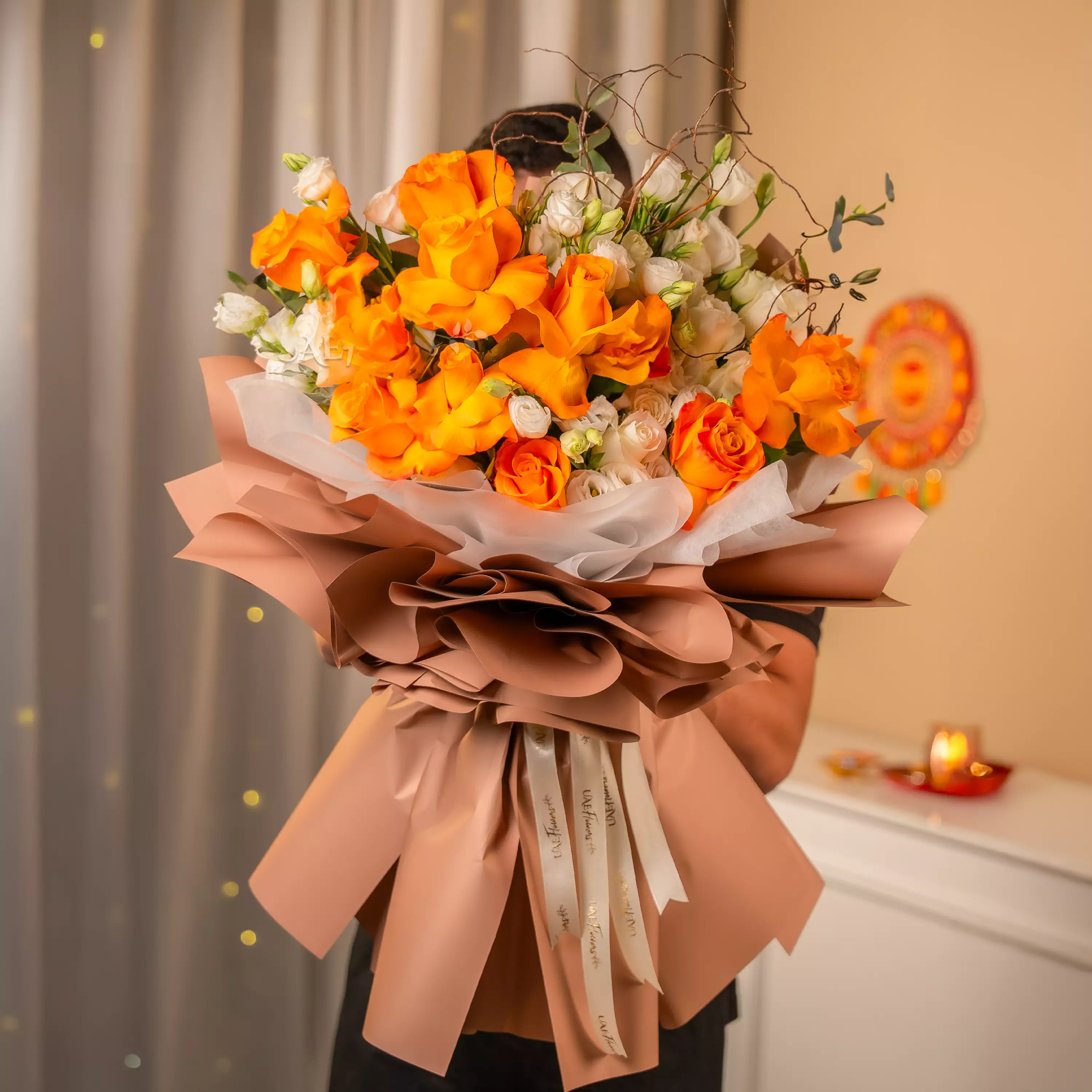 Orange and white rose bouquet with festive wrapping for Diwali by UAE Flowers Dubai