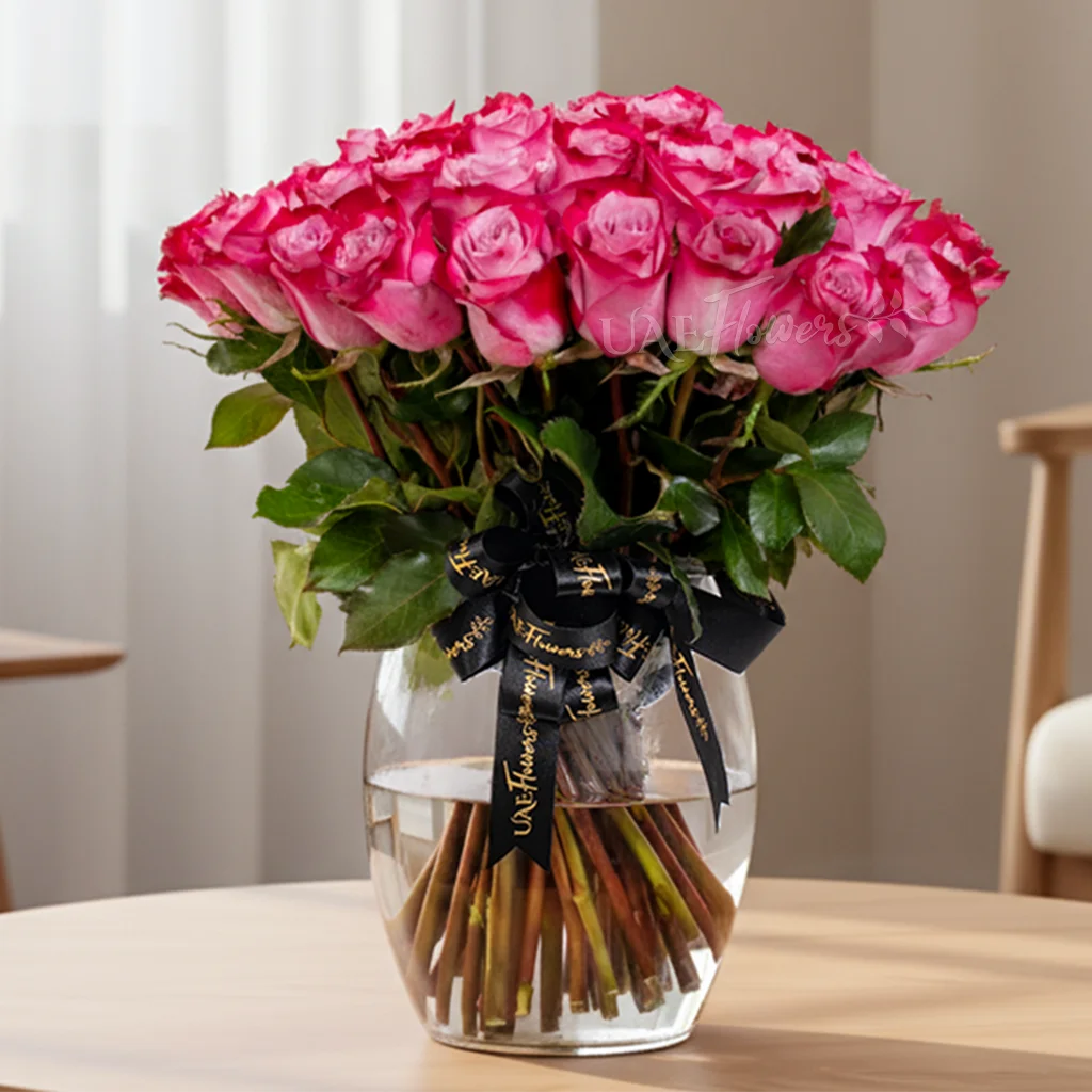 glass vase with 40 purple roses and green fillers