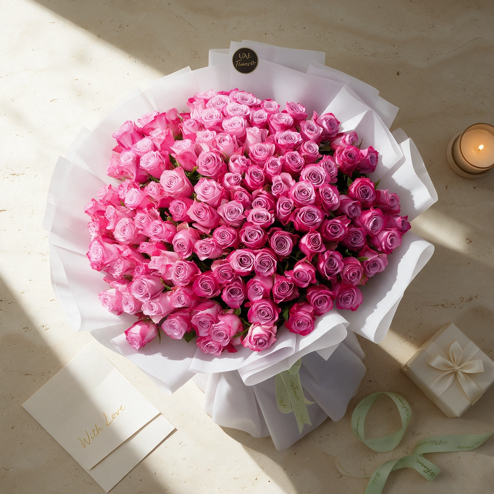 100 purple roses with fillers, wrapped in white paper and tied with ribbons