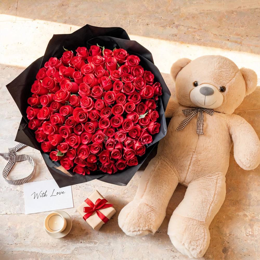 bouquet of 100 red roses in black paper wrap with ribbons and a brown jumbo teddy bear
