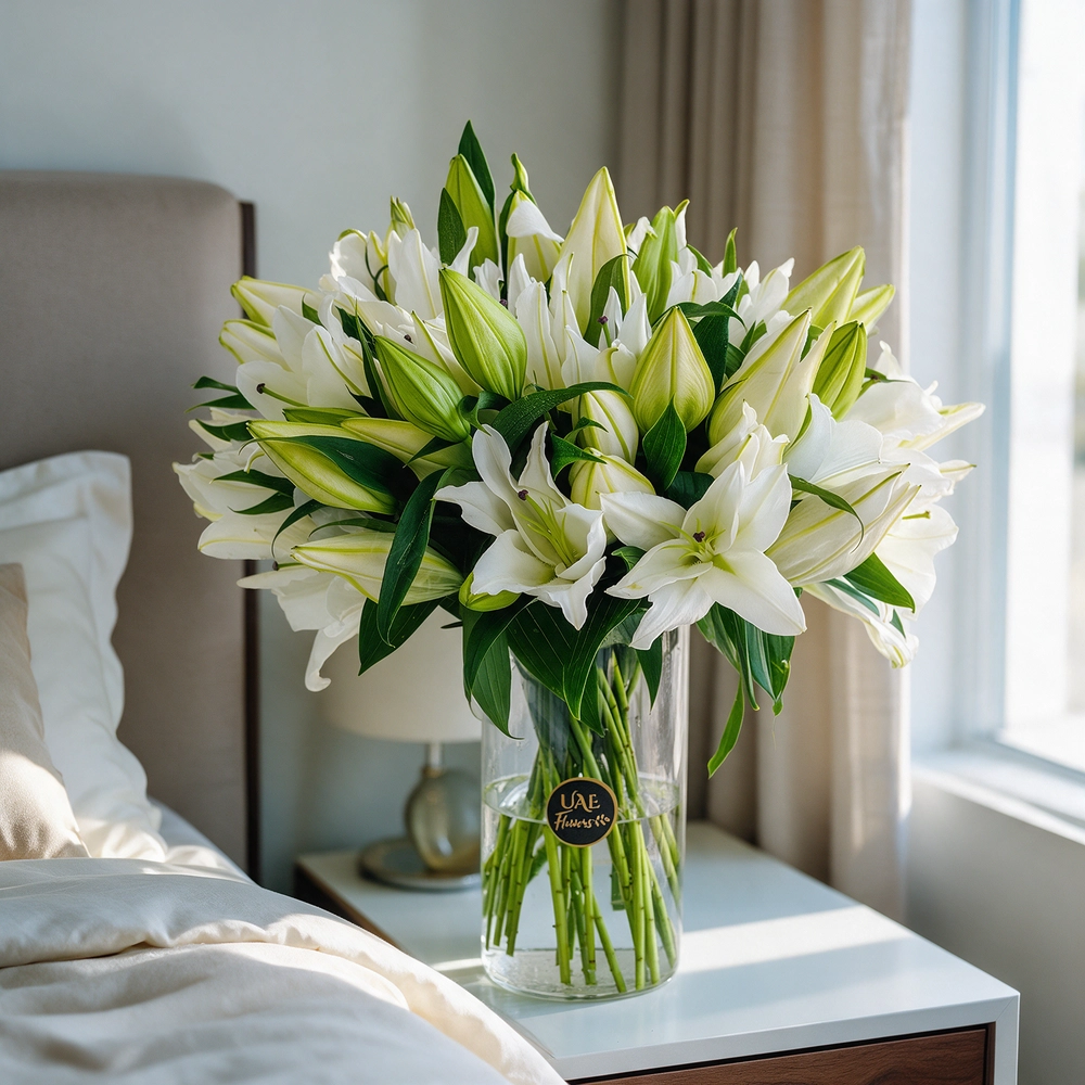 15 white lilies with green fillers in a glass vase