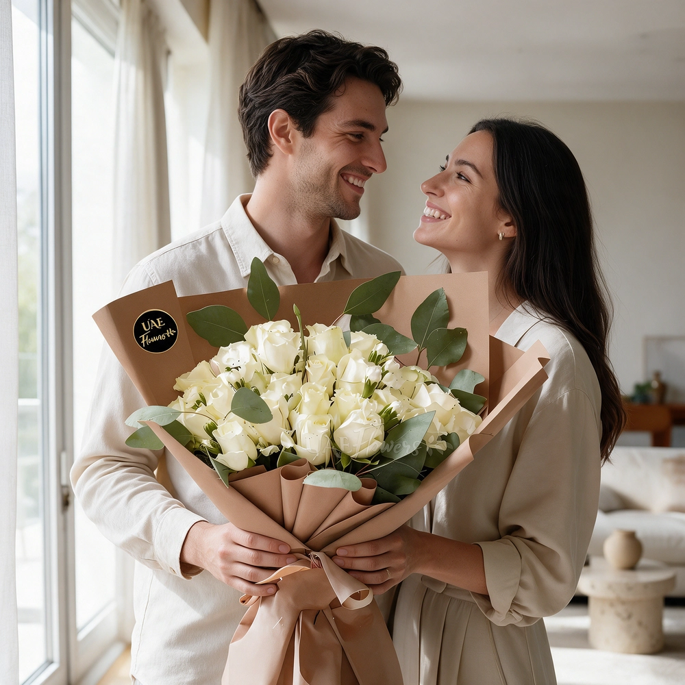 A bouquet of 20 white roses with green fillers in brown wrapping paper tied with brown ribbon