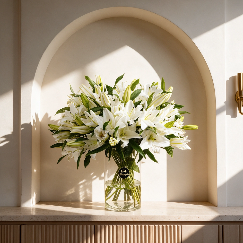 Glass vase with 20 white lilies elegantly arranged, perfect as a centerpiece or gift for weddings, anniversaries, or special occasions.