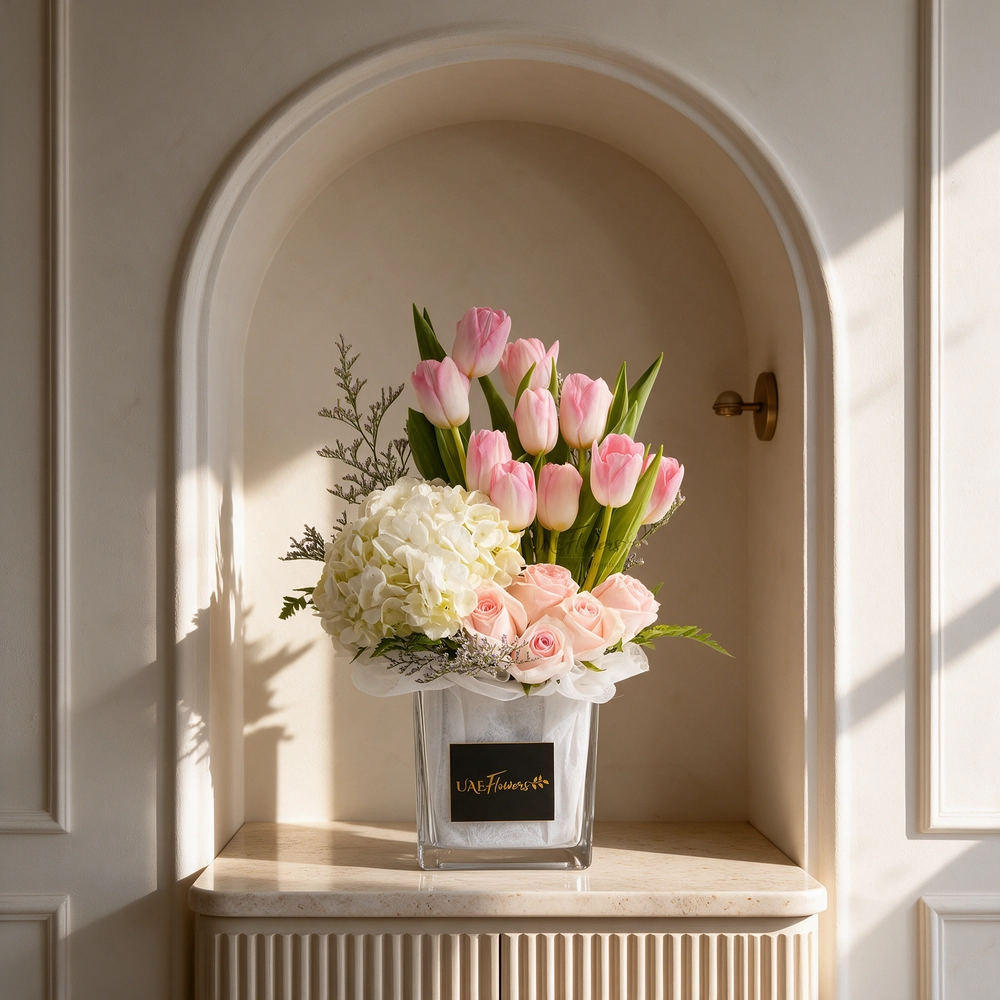 10 pink tulips, 6 pink roses & white hydrangea in a vase