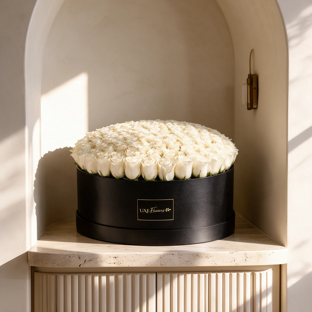 120 white roses neatly arranged in a box
