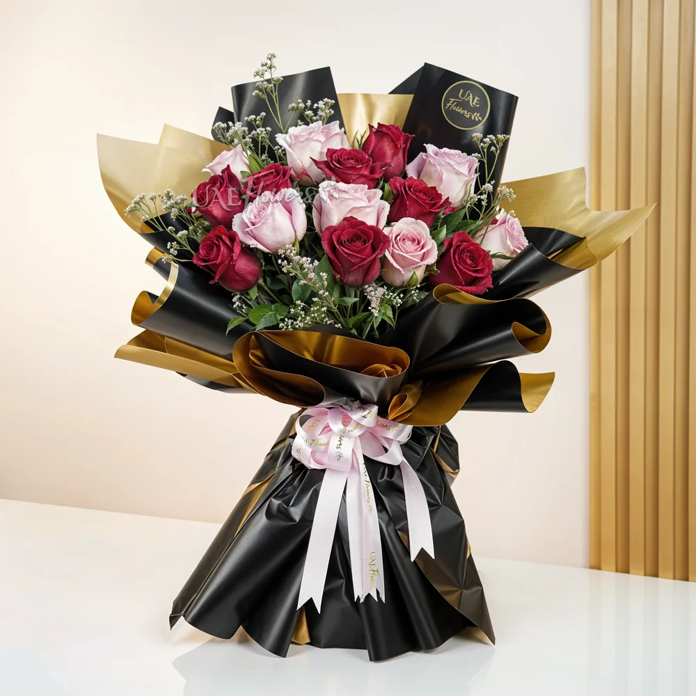 A bouquet of 20 pink and peach roses with green fillers and eucalyptus leaves, baby's breath in pink wrapping tied with pink ribbon