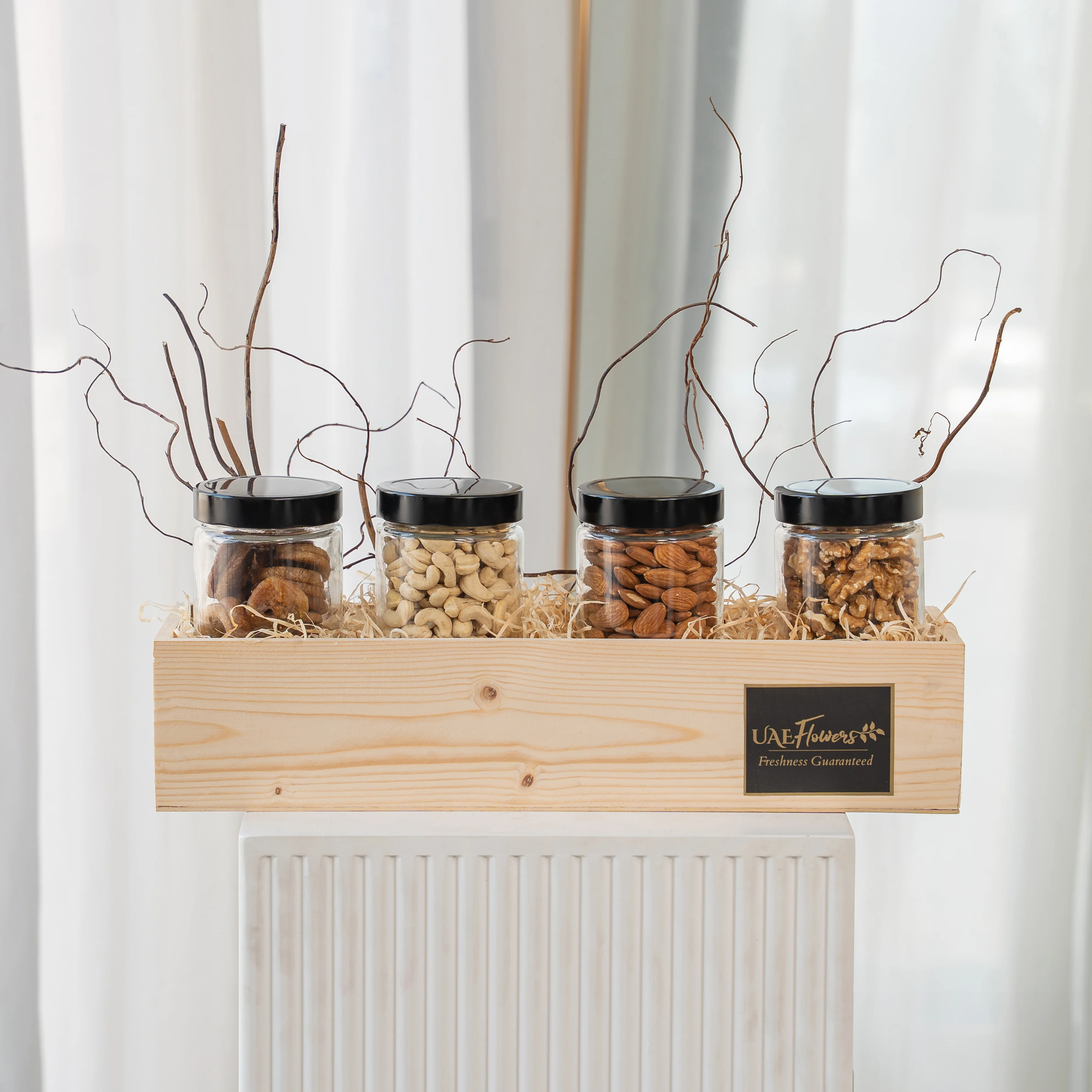 Sets of Dried Figs, Walnuts, Almonds and Cashew in a wooden tray.