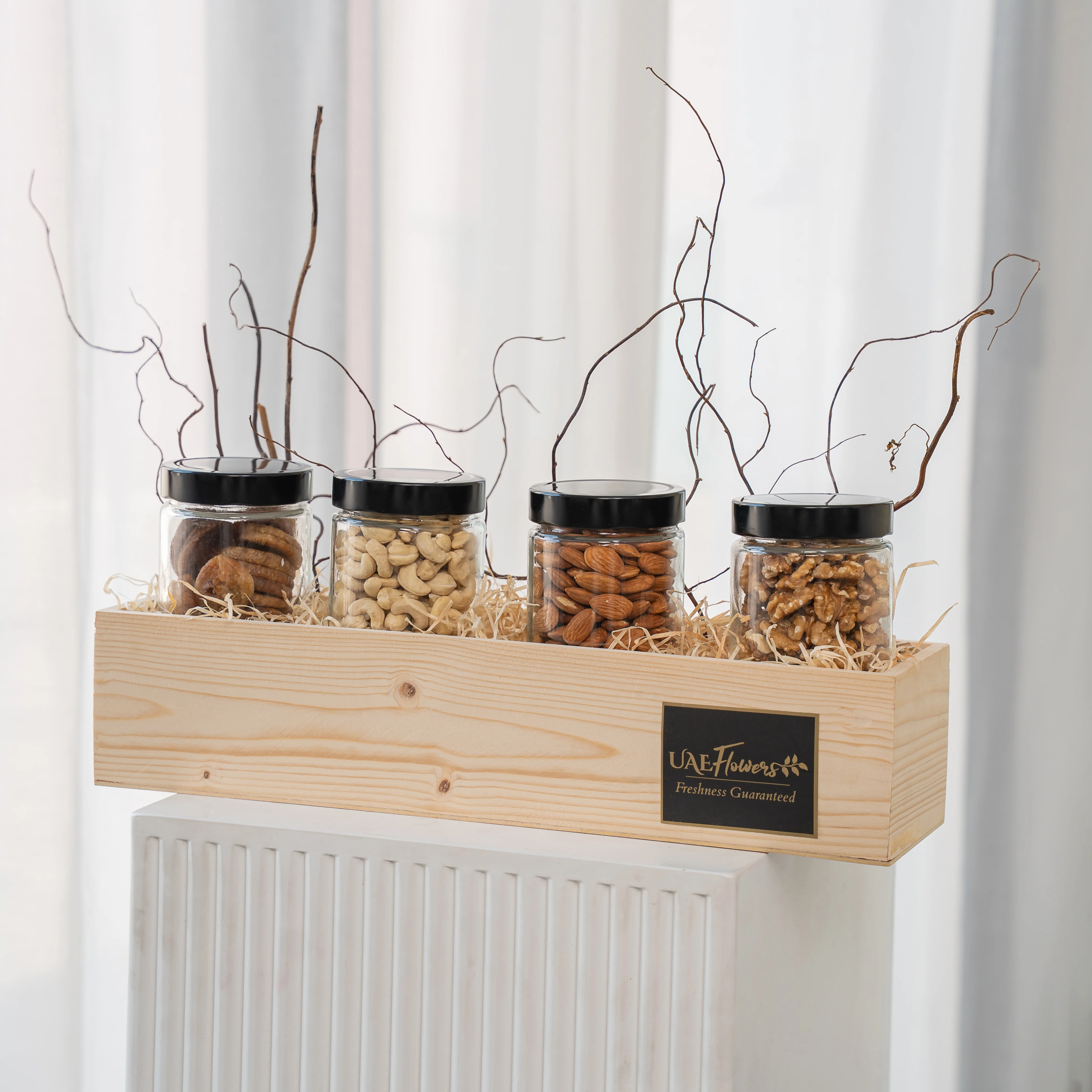 Sets of Dried Figs, Walnuts, Almonds and Cashew in a wooden tray.