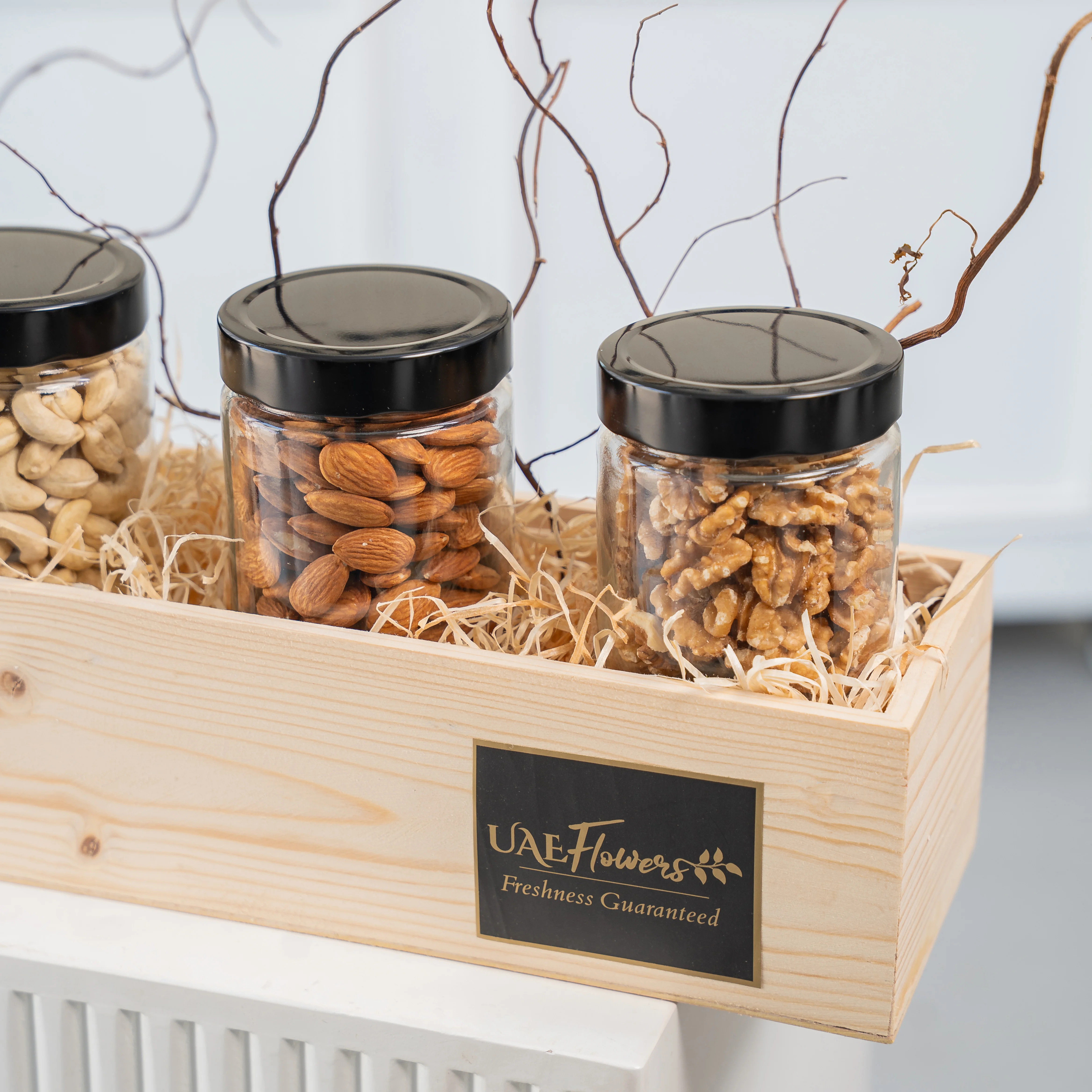 Sets of Dried Figs, Walnuts, Almonds and Cashew in a wooden tray.