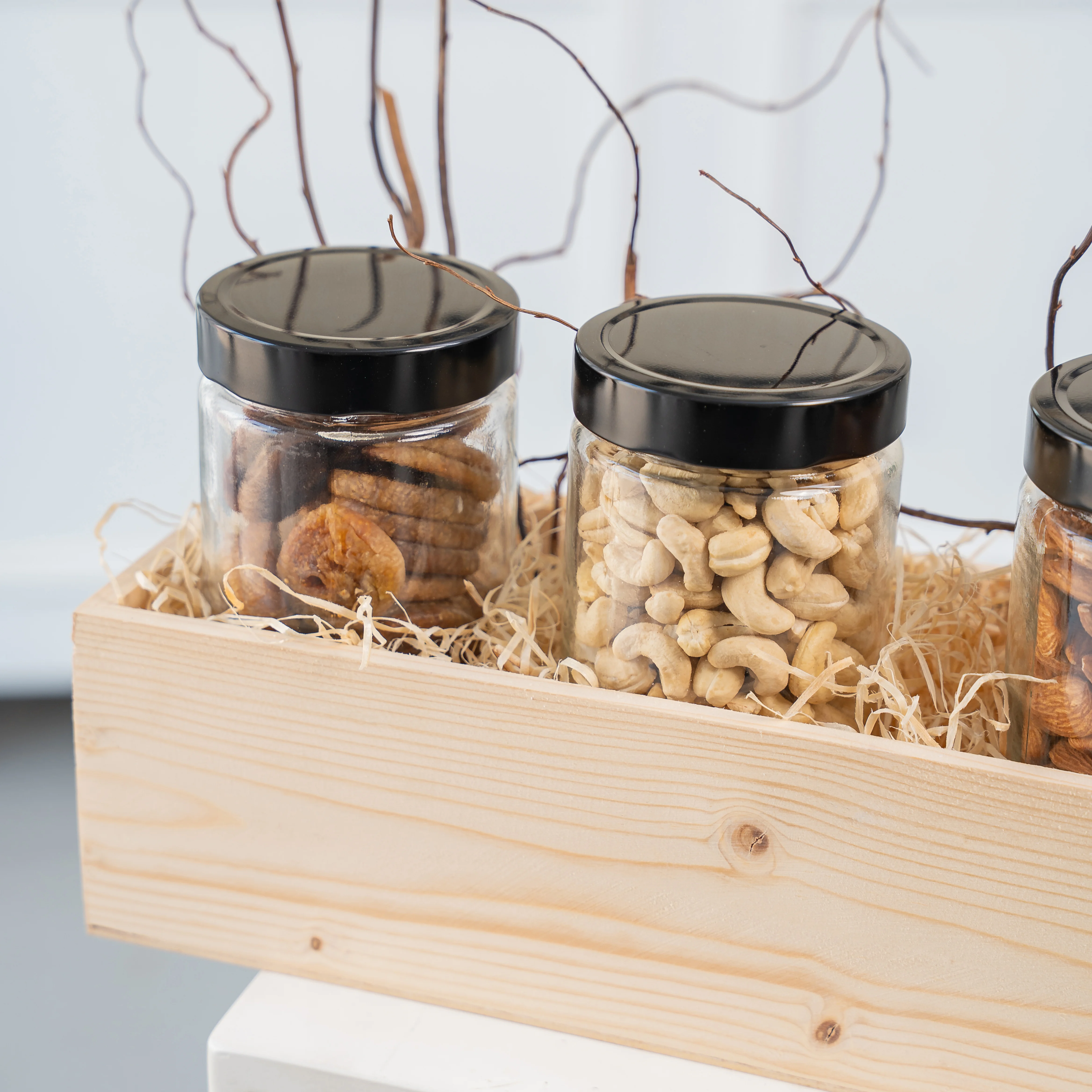 Sets of Dried Figs, Walnuts, Almonds and Cashew in a wooden tray.