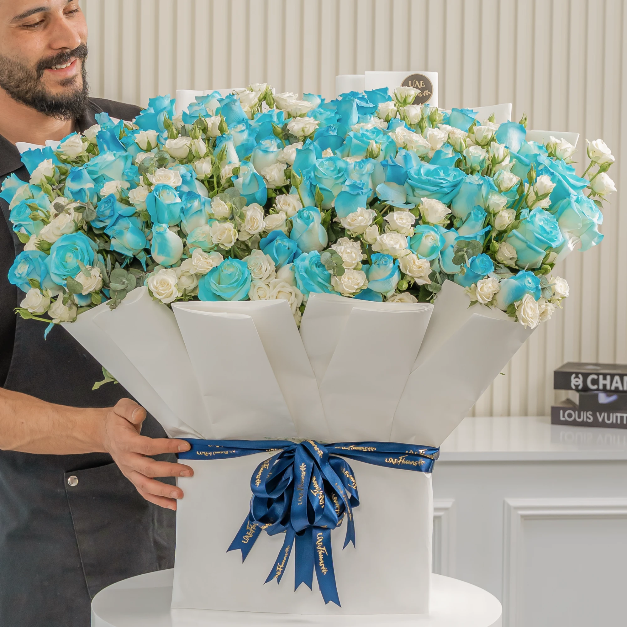 bouquet of 20 white spray roses and 30 blue sprayed roses with green fillers