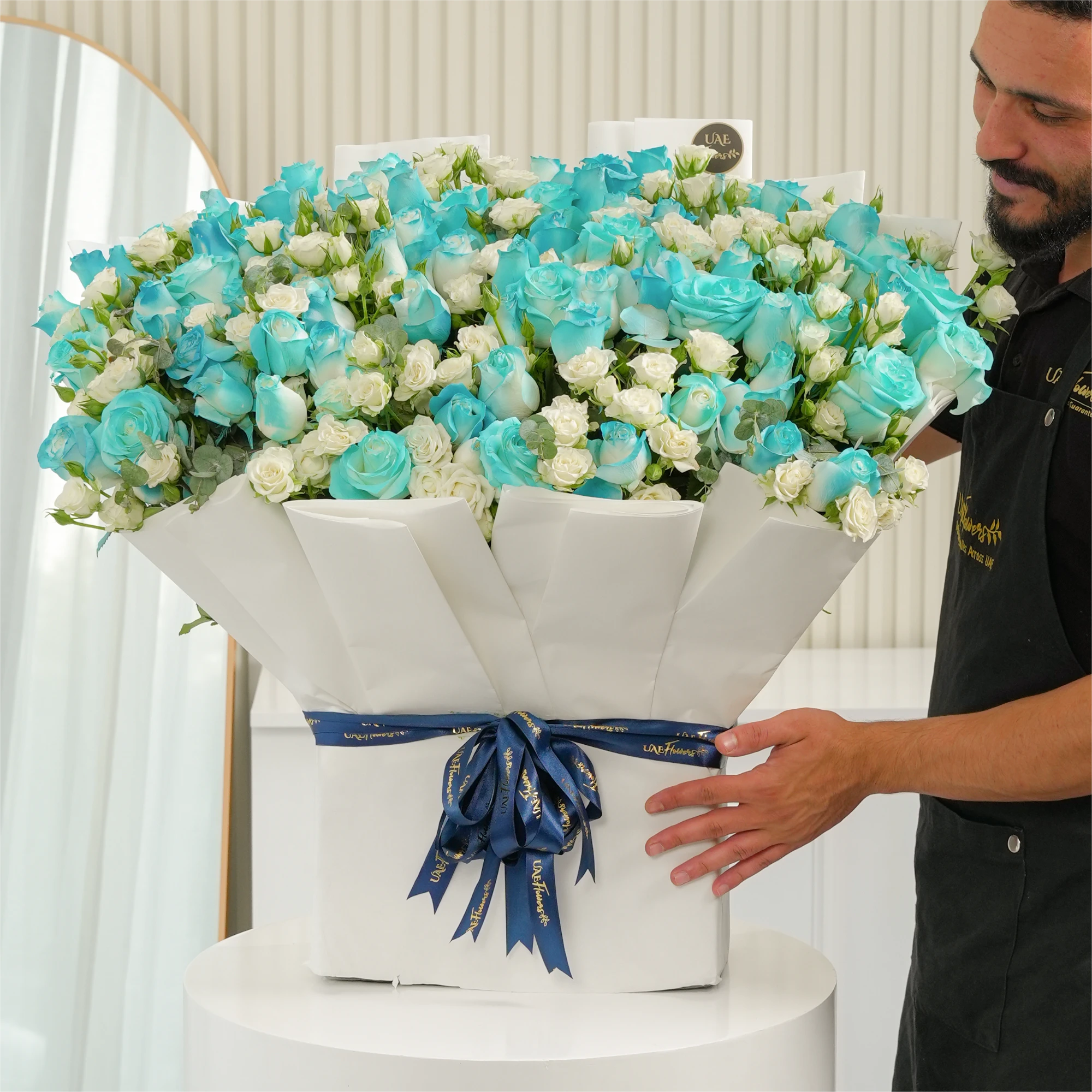bouquet of 20 white spray roses and 30 blue sprayed roses with green fillers
