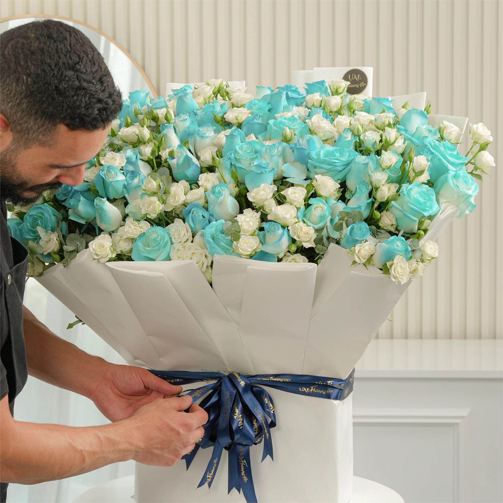 bouquet of 20 white spray roses and 30 blue sprayed roses with green fillers