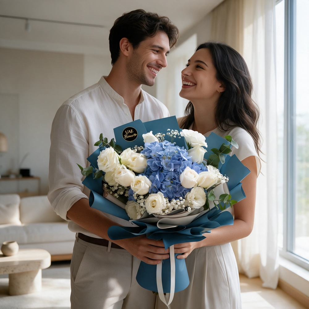 A bouquet of 1 blue hydrangea and 14 white rose with baby breath in blue and white wrapping paper tied with white ribbon