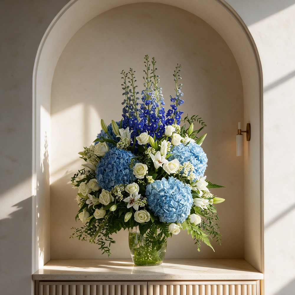 4 blue hydrangeas, 8 white lilies, 5 blue delphinium, and 20 white roses