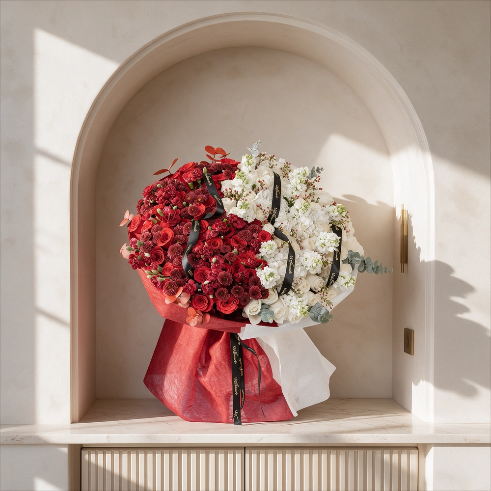 Bouquet of 25 red roses, 15 red chrysanthemums, 10 red spray carnations, 3 white hydrangeas, 25 white roses and 10 white matthiola with eucalyptus leaf in red and white wrapping paper tied with ribbon.